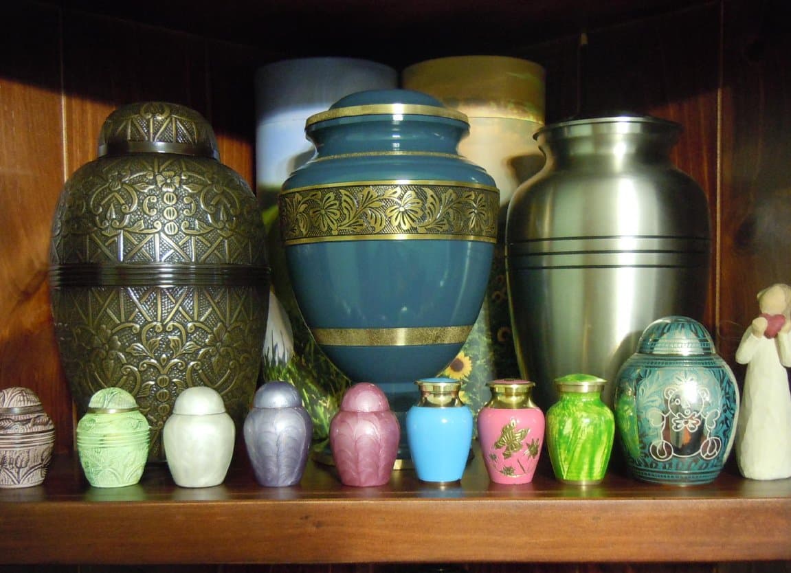 A display of cremation urns in various sizes, colours and finishes
