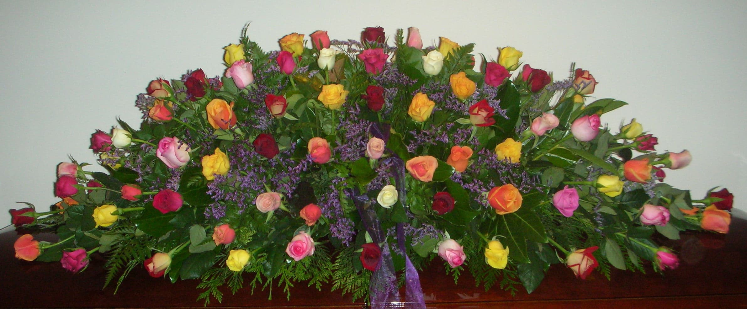 Mixed colour roses casket spray