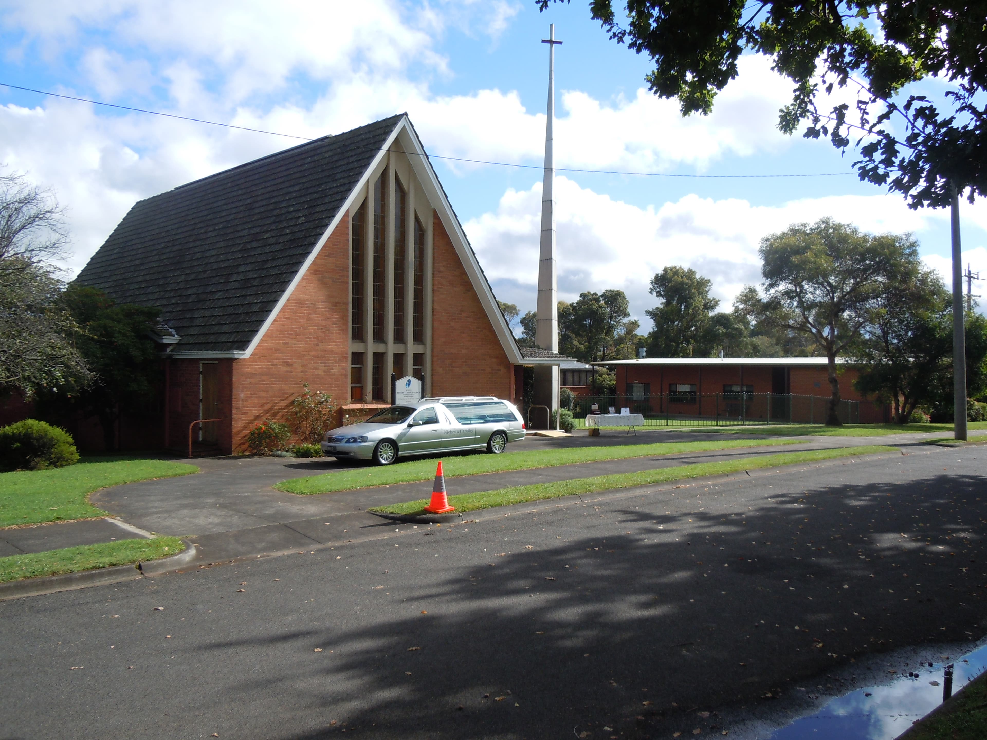 Scots Presbyterian Church, Drouin, with a hearse parked outside