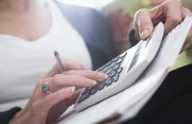 Hands using a calculator